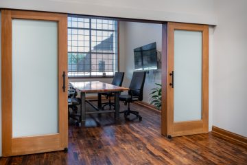 View of JRF Construction’s Cicero office, showcasing a brick exterior with large windows and modern design accents.